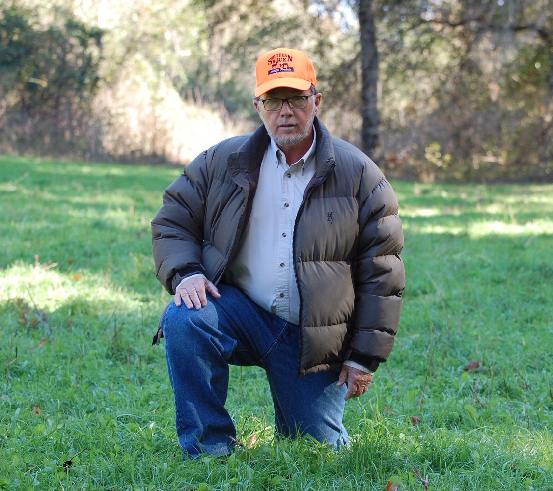 Southern Seed and Feed employee kneeling outside