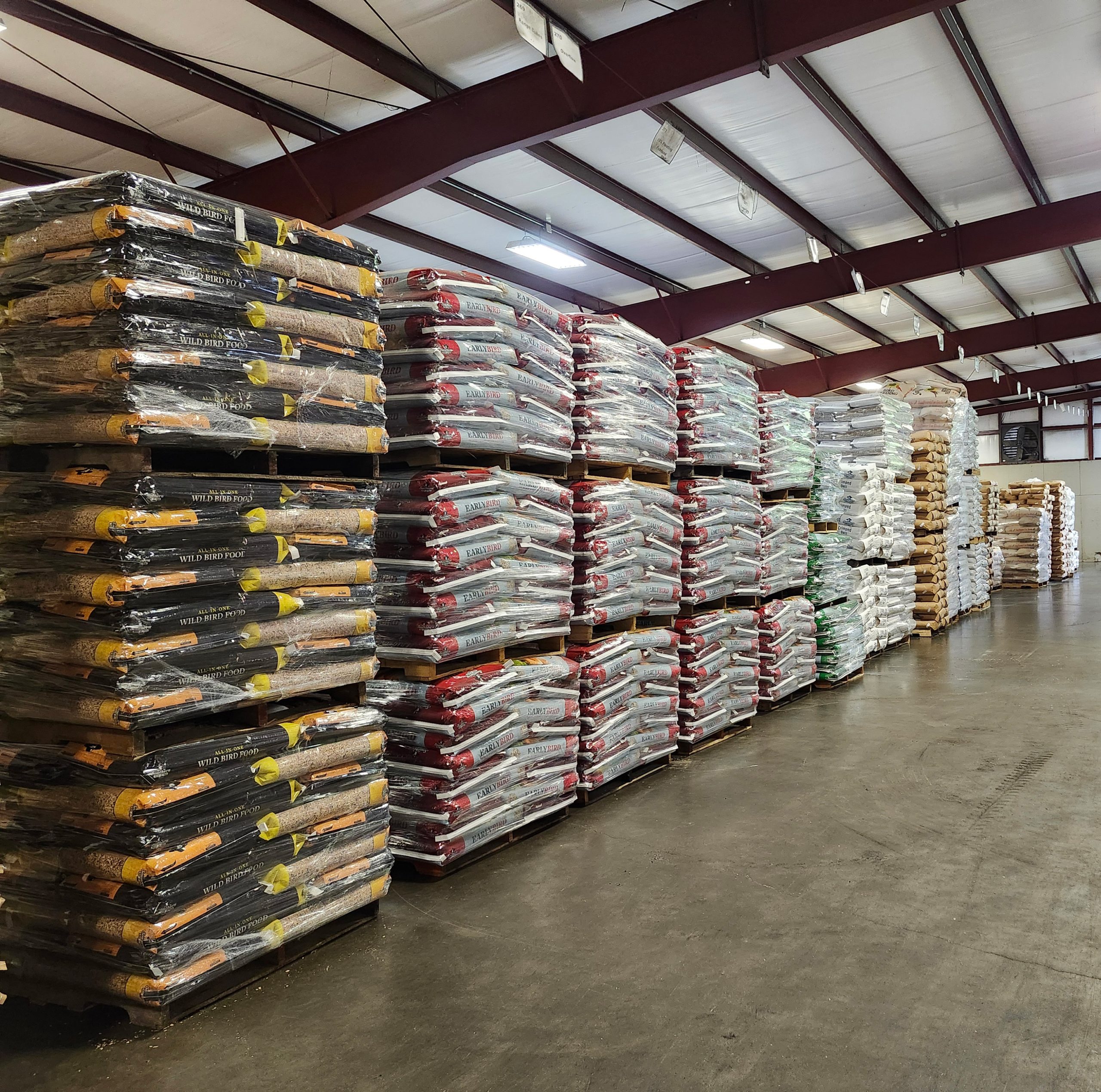 Bags of feed stacked in a warehouse